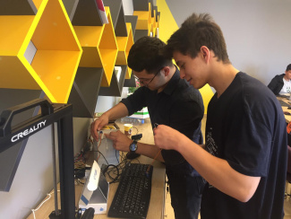 Two students preparing the smart recycling system