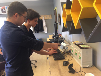 Two students preparing the smart recycling system